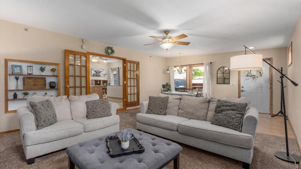 a living room with two couches and a ceiling fan at 2BR Condo by Lake w Deck, Jetted Tub - Raindrop in Pepin