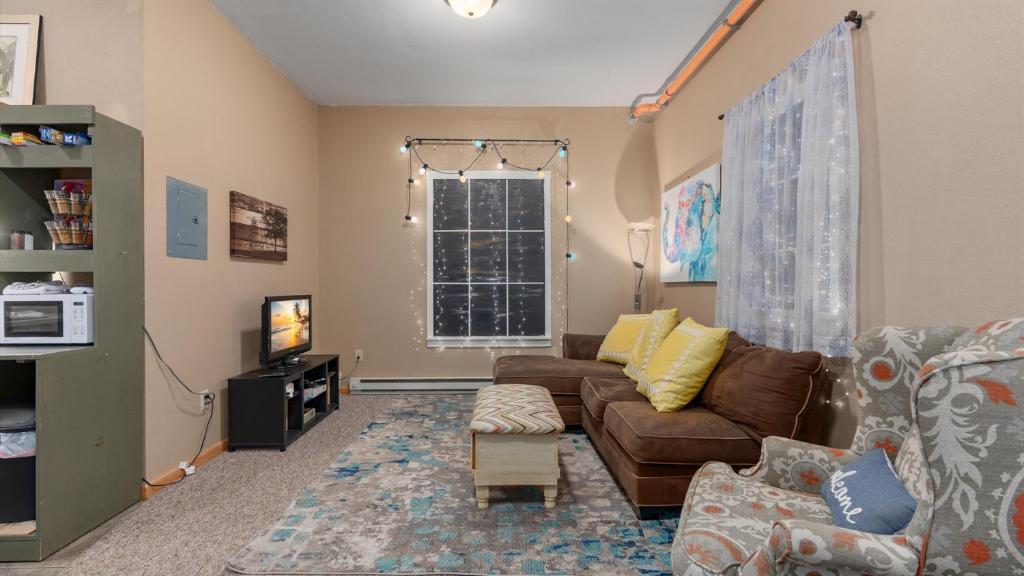 a living room with a couch and a window at Three Connected Quirky Condos By Beach! - Twilight Condo in Pepin