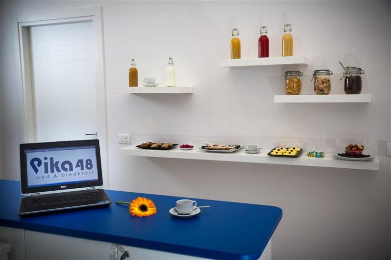 a laptop computer sitting on a blue desk in a room at B&B Pika 48 in Naples