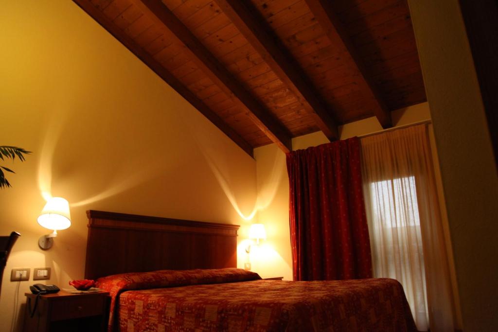 Postel nebo postele na pokoji v ubytování Hotel Il Borghetto