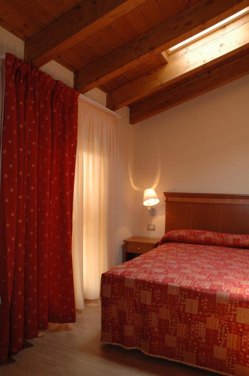 Postel nebo postele na pokoji v ubytování Hotel Il Borghetto