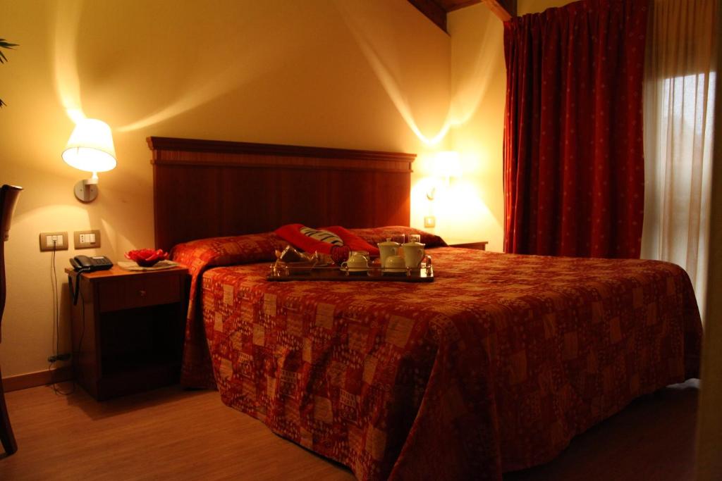 Postel nebo postele na pokoji v ubytování Hotel Il Borghetto