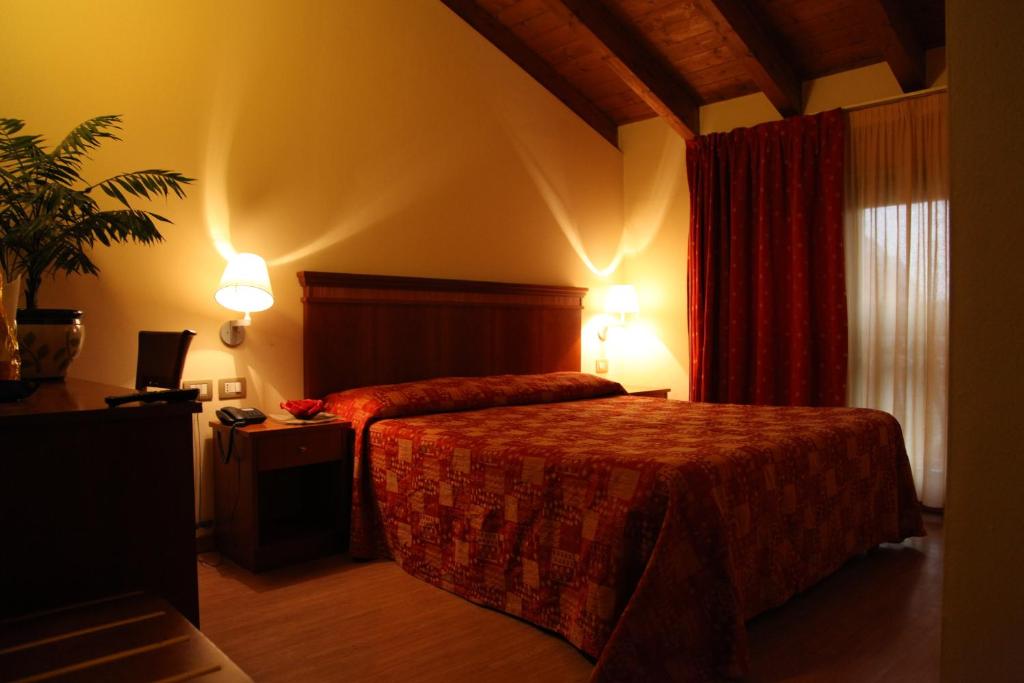 Postel nebo postele na pokoji v ubytování Hotel Il Borghetto