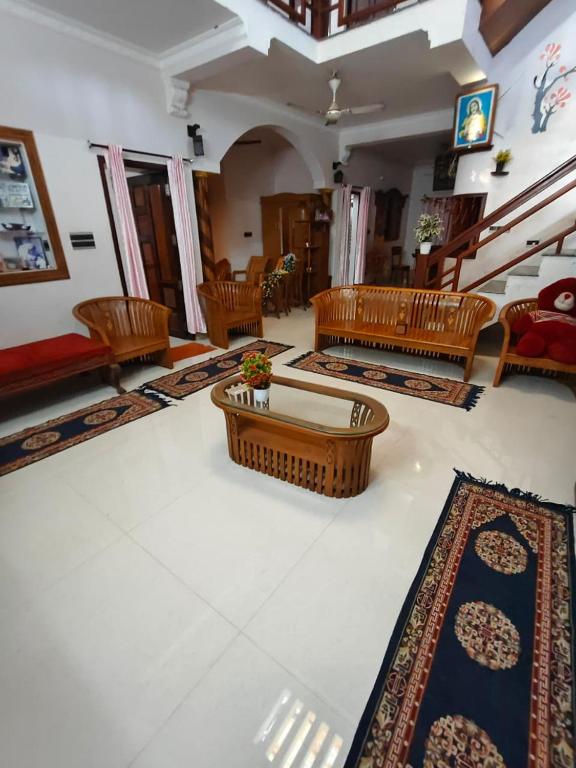 a living room with tables and rugs on the floor at Cozy Nest in Pūvār