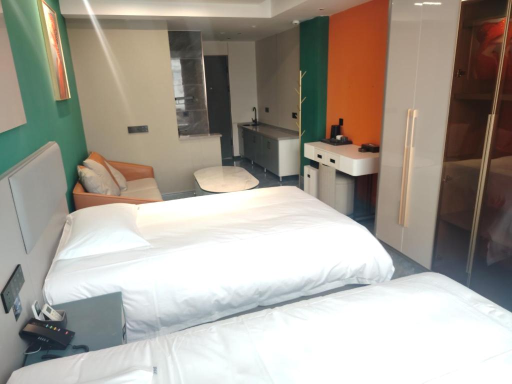 a hospital room with two beds and a sink at 义乌君威酒店 in Yiwu