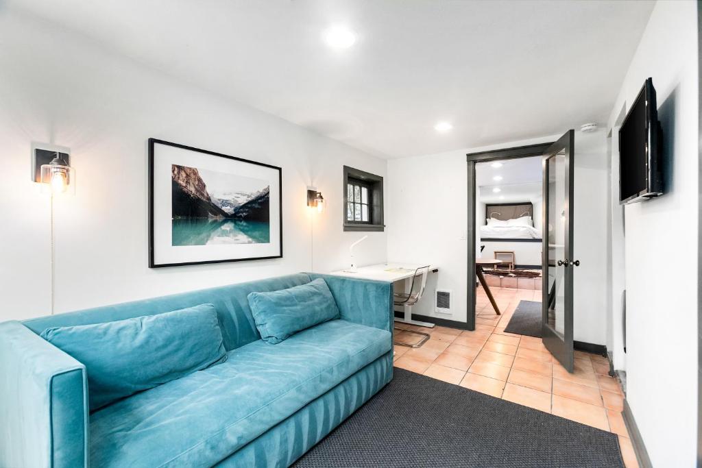 a living room with a blue couch and a desk at Montlake Studio in Spite House in Seattle