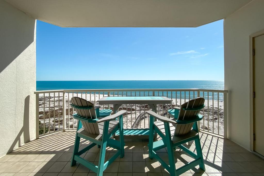 a balcony with a table and chairs and the ocean at Catalina 902-Updated Beachfront Condo with Amazing Views-Full Service Resort in Gulf Shores