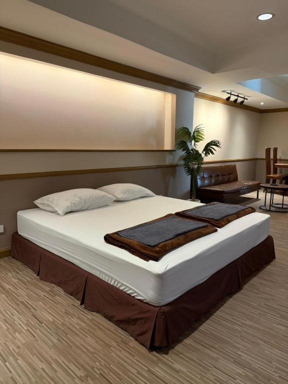 a bedroom with a large bed in a room at Alameda Suites Hotel in Bangkok