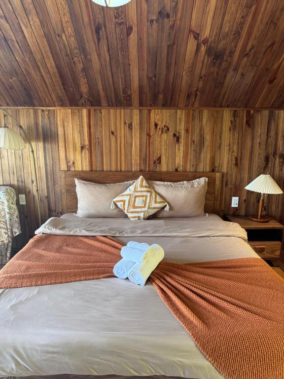 a bedroom with a bed with two towels on it at City Dodge Home in Xuan An