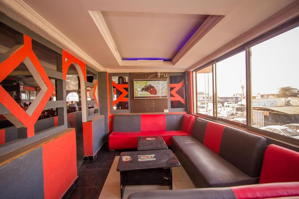 a room with a couch and a table at Hotel Nomad in Athi River