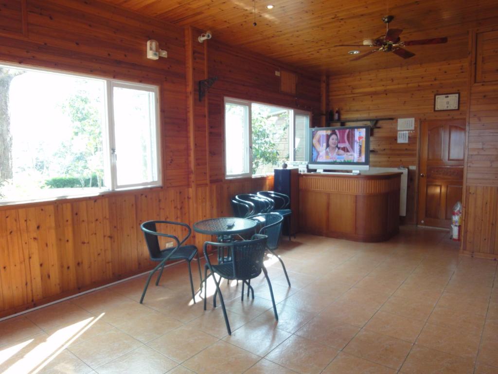 a room with a table and chairs and a tv at Natural Residence B&amp;B in Tai&#39;an