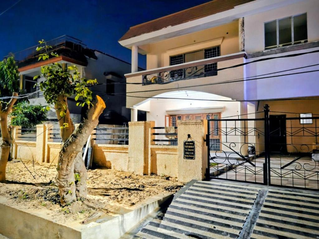 a house with stairs leading to the front door at Vijay Mansion Pratap Enclave in Jaipur