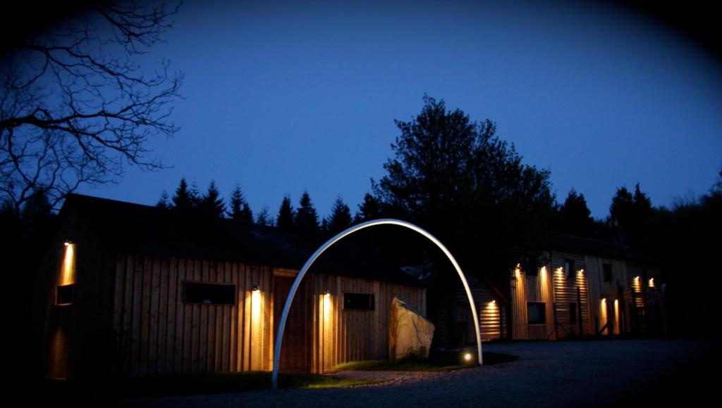 a building with an arch in front of it at night at The Lodge Rooms in Coleford
