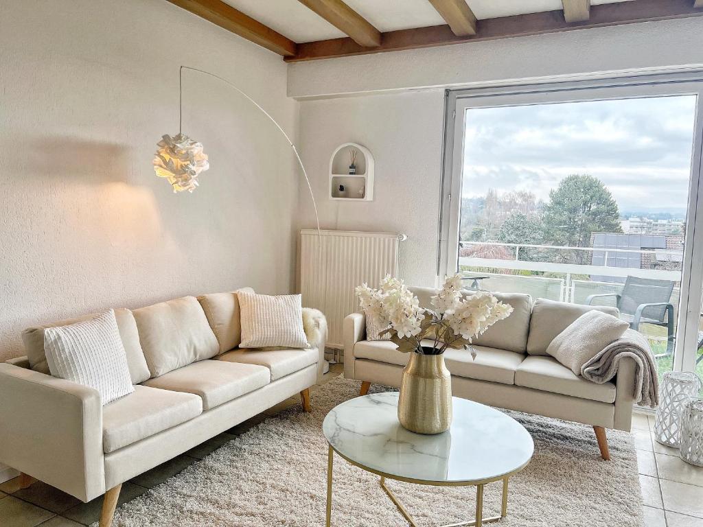 a living room with a couch and a table at Horizon Lac - wifi - parking in Morges