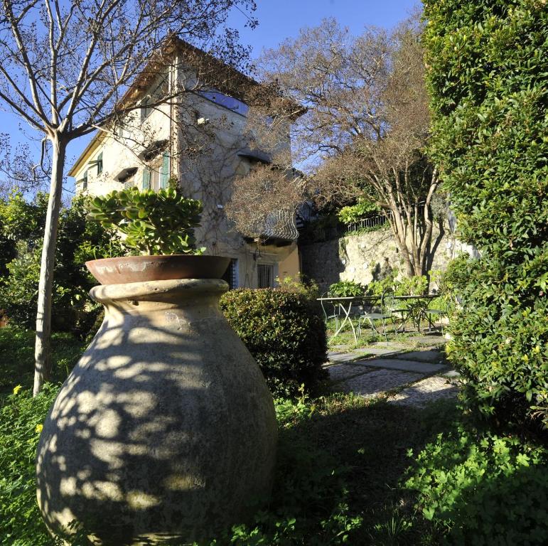 a large stone vase sitting in front of a house at Agriturismo La Contessa in Finale Ligure