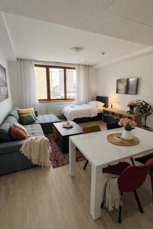 a living room with a couch and a bed in a room at Central Walk Apartment in Bratislava
