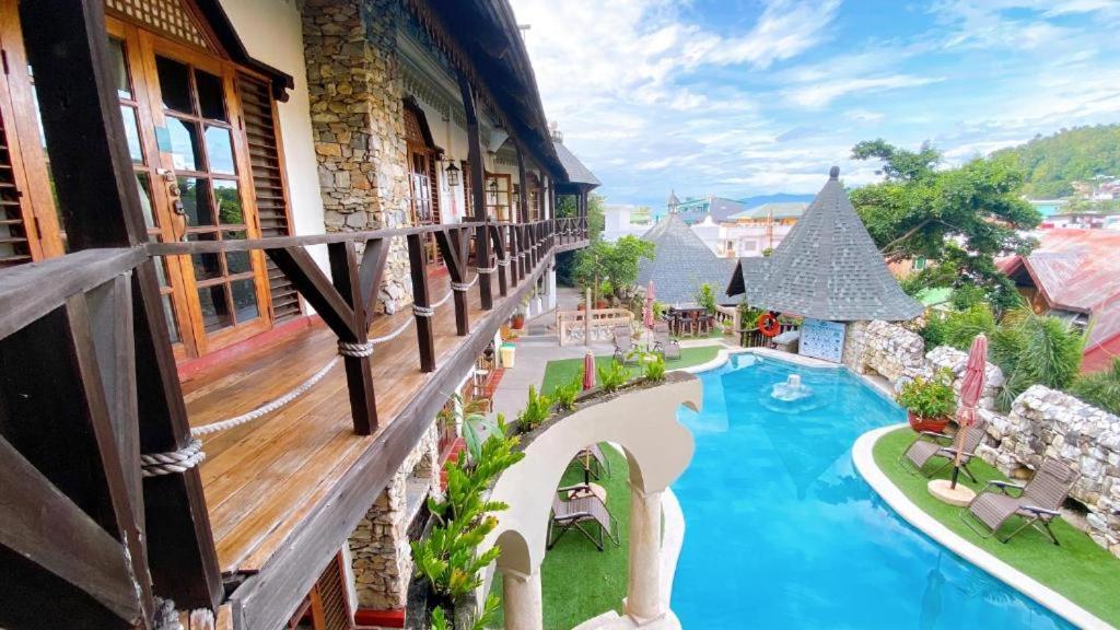 a balcony of a hotel with a swimming pool at Hotel Tropicana Castle Sabang Mindoro in Sabang