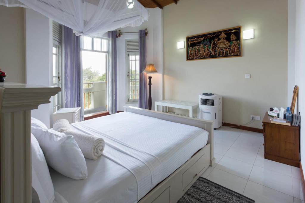 Postel nebo postele na pokoji v ubytování Vista House Kandy