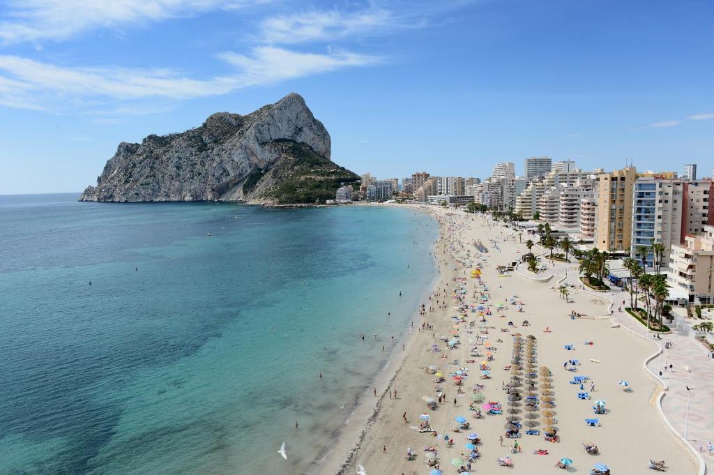an aerial view of a beach with people and buildings at La Luz Costa Calpe in Calpe