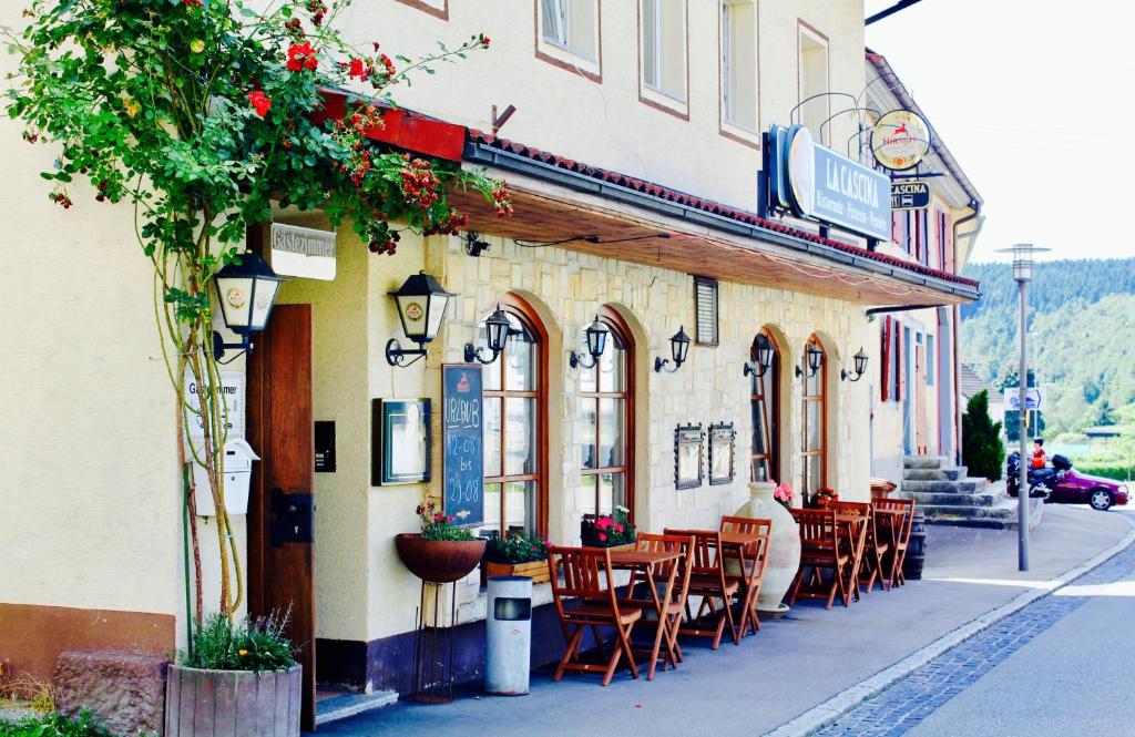 トゥットリンゲンにあるPension La Cascinaの通りにテーブルと椅子が並ぶレストラン