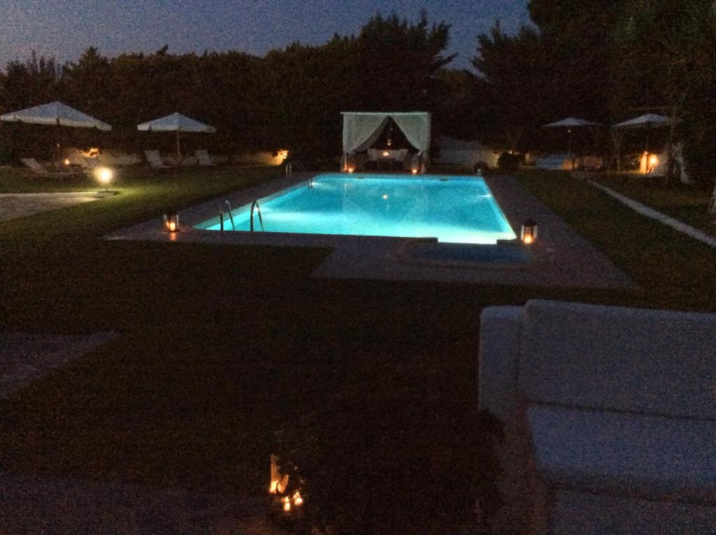 a swimming pool at night with lights at Dimeon Villa in Kato Achaia
