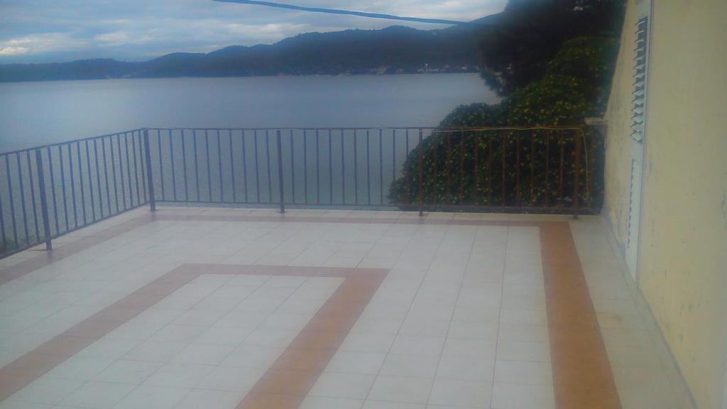 a balcony with a view of a body of water at Holiday Home Smokvica in Viganj