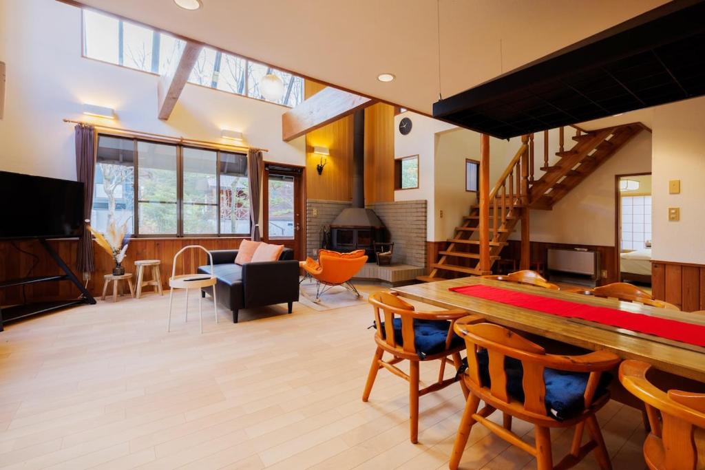 a living room with a ping pong table and chairs at 山水苑-道-温泉付き貸別荘ガイアリゾート in Zao