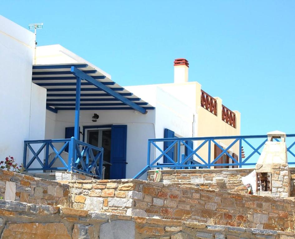 a house with a blue balcony and a building at Endless Blue from Syros - Fabrika House 1 & 2 in Vári