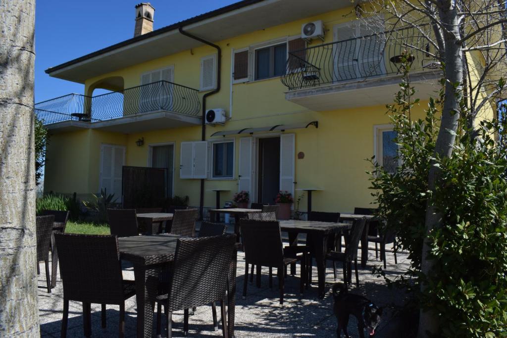 a patio with tables and chairs in front of a building at Villa Marianna in Vasto