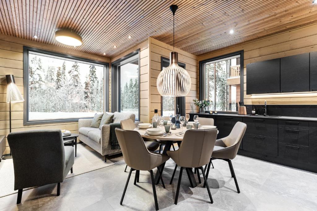 a dining room and kitchen with a table and chairs at Bimmel Arctic Suite by PolarVillas in Kittilä