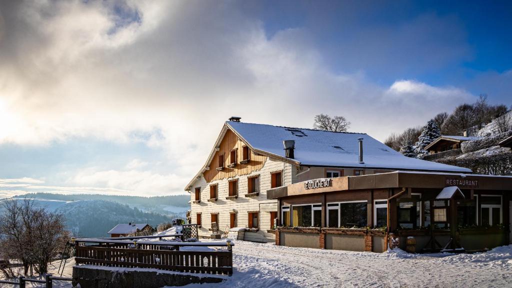 a building on top of a snow covered mountain at Hôtel - Restaurant Le Couchetat in La Bresse