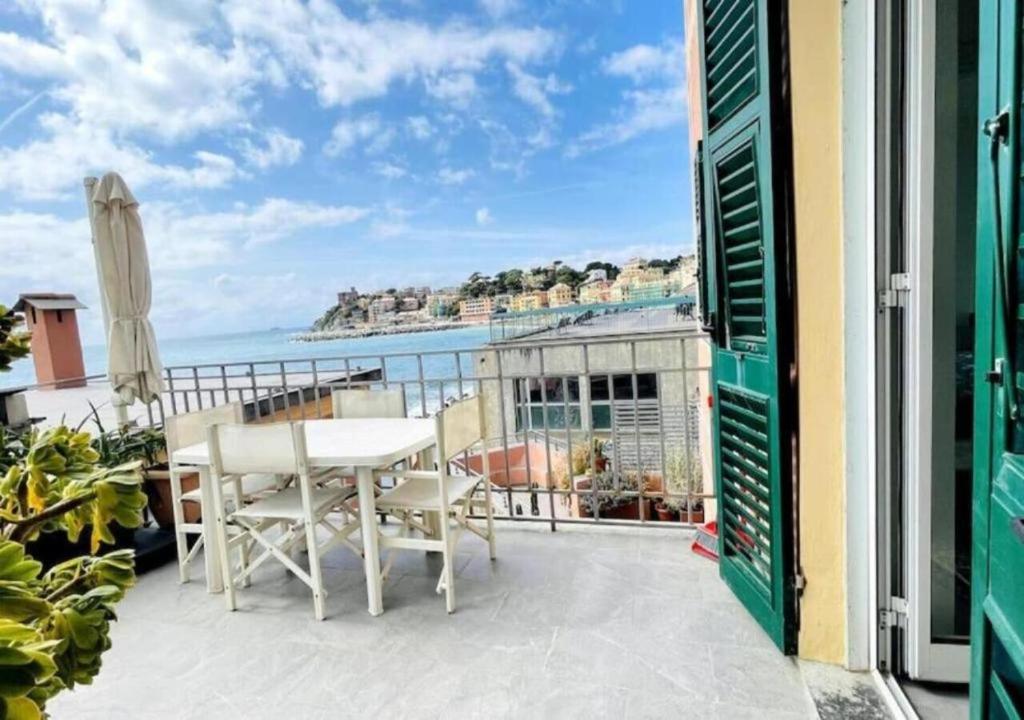 a balcony with a table and a view of the ocean at Comodissimo Gaslini e mare in Genoa