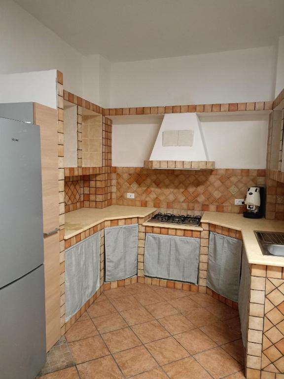 a kitchen with a stove and a refrigerator at Fabian Appartament in Bagheria