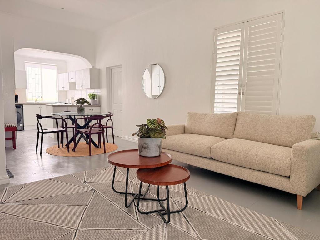 a living room with a couch and a table at Crescent House in Franschhoek