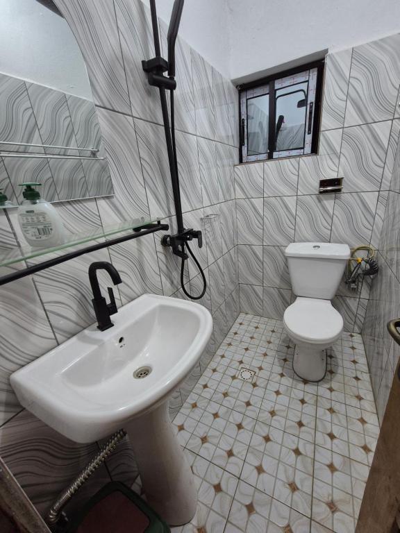 a bathroom with a sink and a toilet at G and E Guesthouse in Kumba