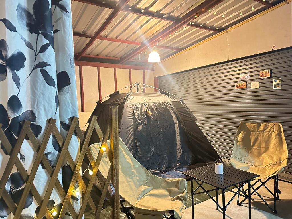 a tent sitting in a room with a table at Stay Like a Local เต็นท์บ้านเรา in Chiang Mai
