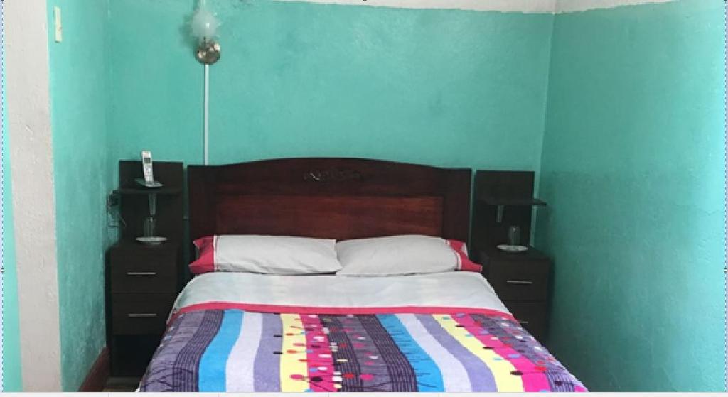 Postel nebo postele na pokoji v ubytování Hostal La Chorrera
