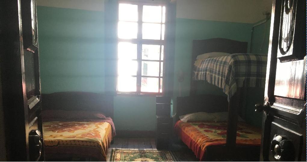 Postel nebo postele na pokoji v ubytování Hostal La Chorrera