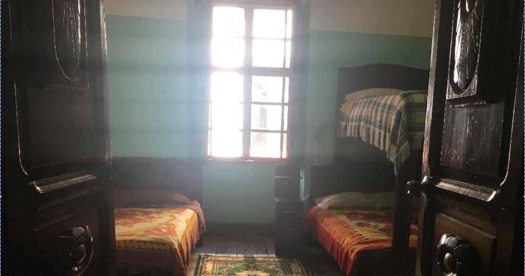 Postel nebo postele na pokoji v ubytování Hostal La Chorrera