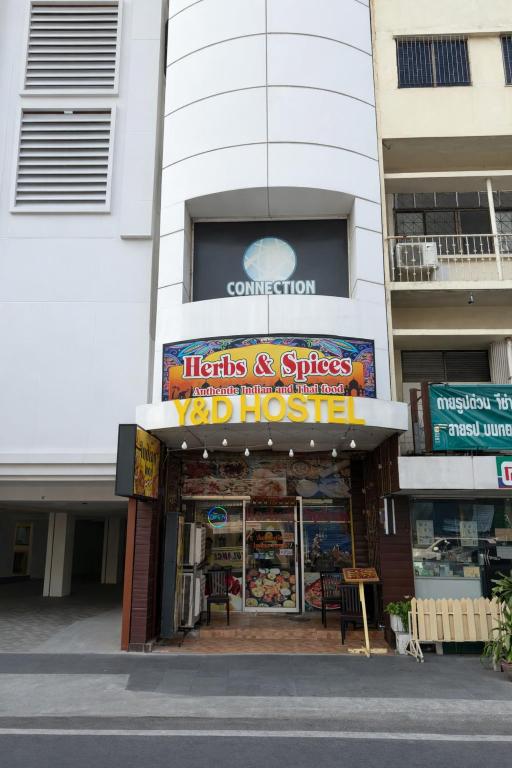 a store with a sign in front of a building at Y&D Hostel in Bangkok