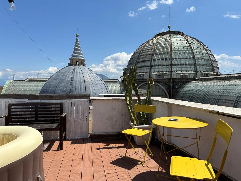a balcony with a table and chairs and two domes at Tiny Nest Over Naples, Private Panoramic Terrace in Naples