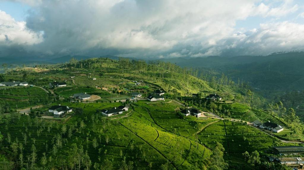 an aerial view of a village on a mountain at Aadya Tea Bungalows by Aahaasa in Hatton