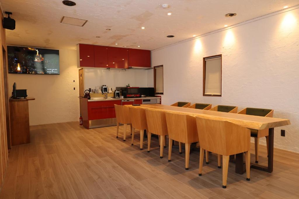 a kitchen with a long wooden table and chairs at Kamakura in Iiyama