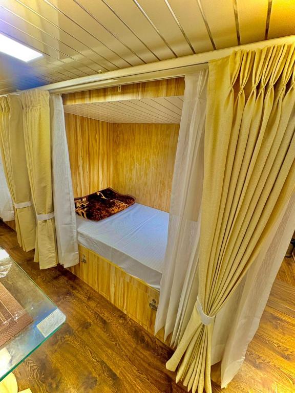 a bedroom with two bunk beds with curtains at Cannaught Stays in New Delhi