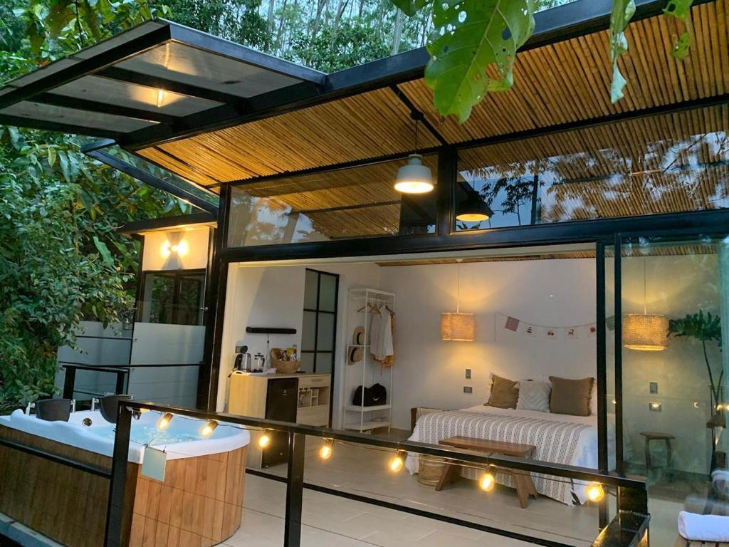a room with a bed and a balcony with lights at La Loma in La Vega
