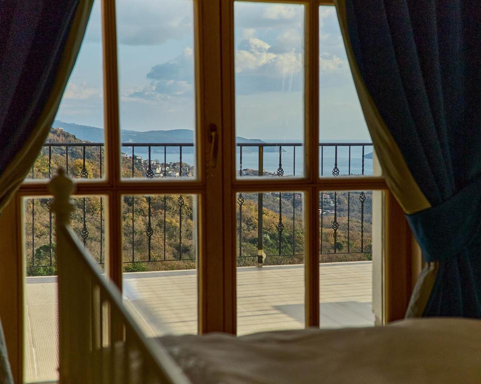 a room with a window looking out at a balcony at Santa Barbara House in Ratiševina