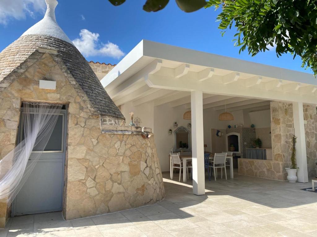 a patio with a stone building with a roof at Casa vacanze Madre Terra in Putignano