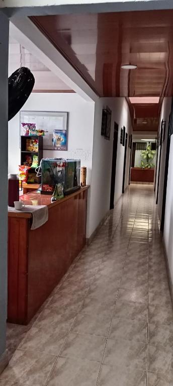 a lobby of a restaurant with a reception counter at Hospedaje Santa Bárbara in Buga