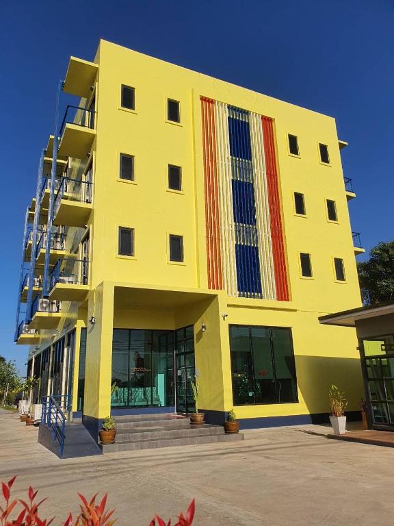 a yellow building with red and blue stripes on it at T-NEE Hotel@Udon in Udon Thani