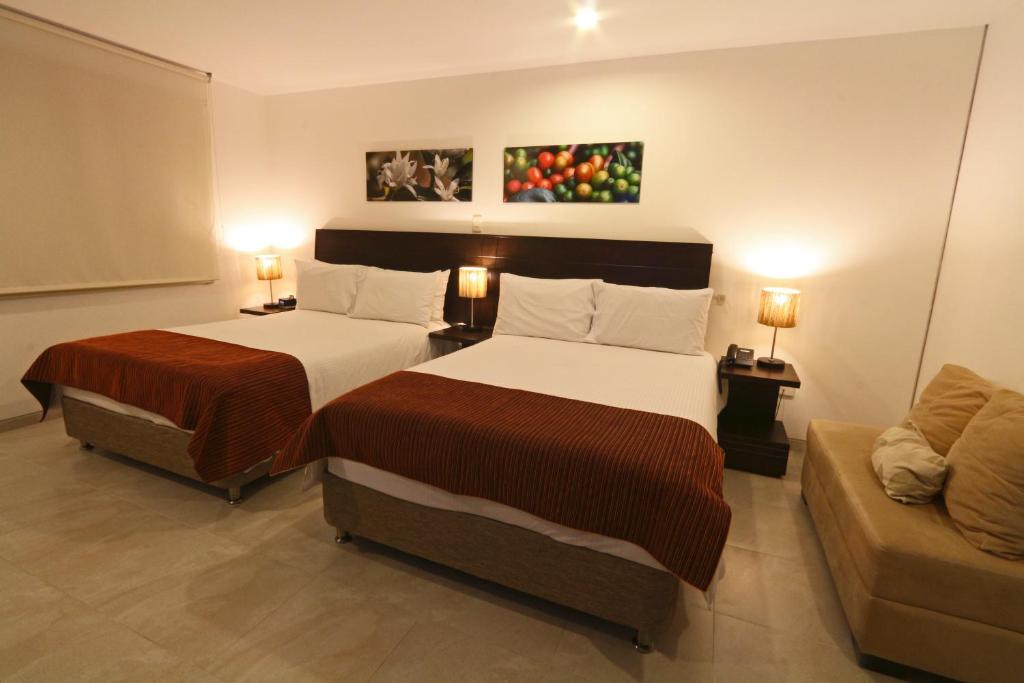a hotel room with two beds and a couch at Hotel Kahvé in Garzón